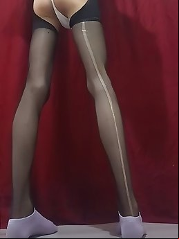 A feminine looking person’s buttocks is penetrated and is under a thin cloth that covers the genitalia.